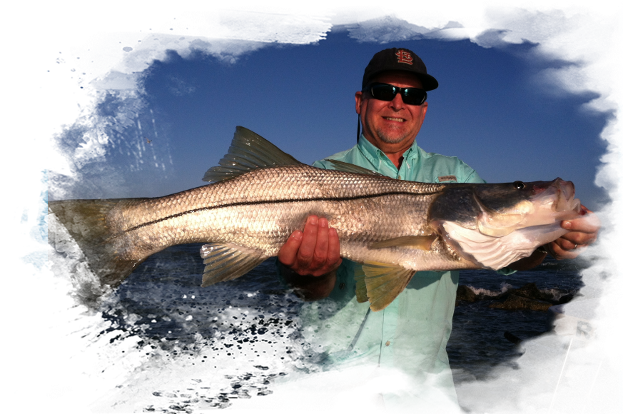 A man holding a large fish in his hands.